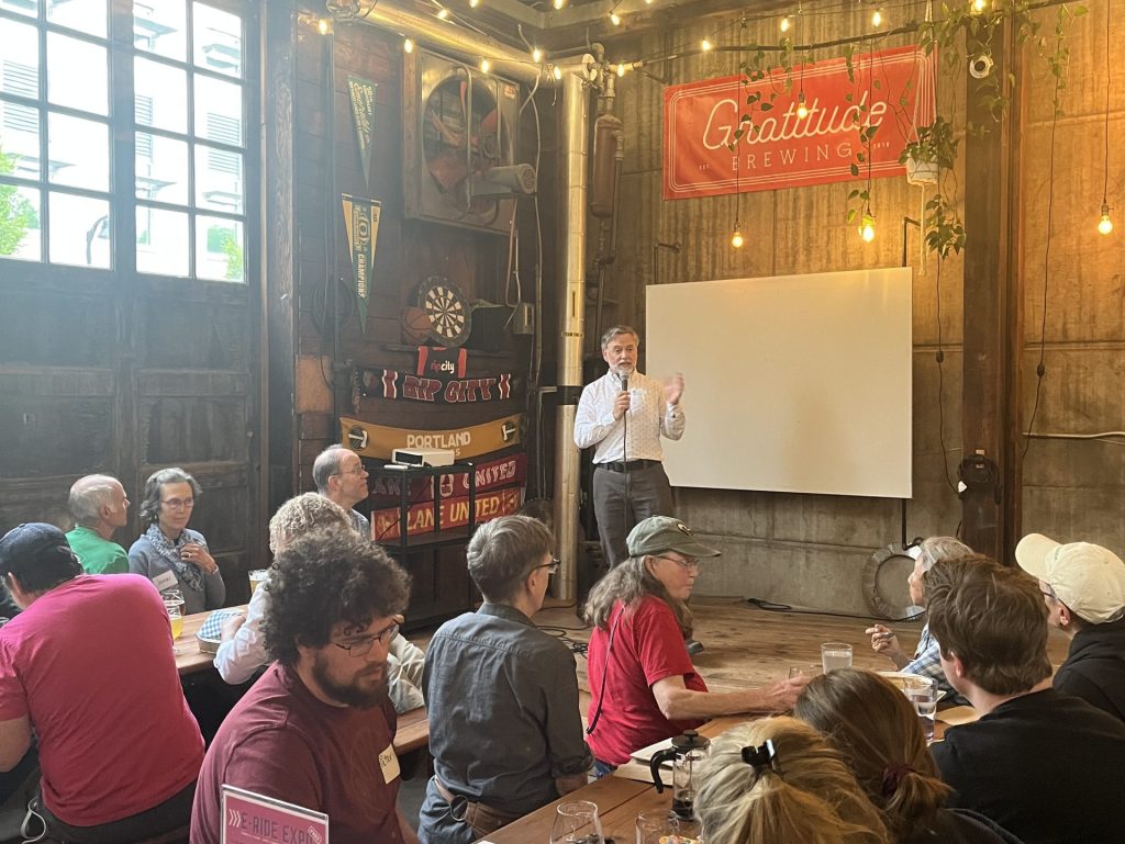 Shane Rhodes speaking to the audience at Gratitude Brewing