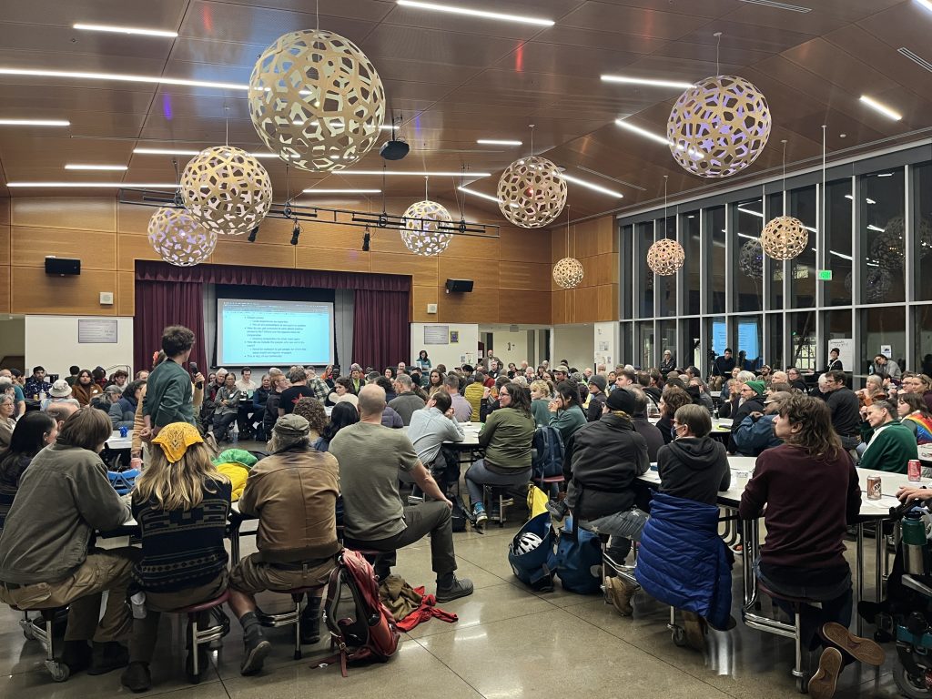 A person speaking to the crowd at the Patterson St Safety Forum